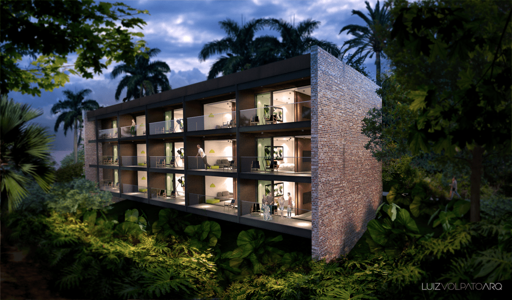 Edifício moderno de três andares com paredes de tijolos expostos e grandes janelas de vidro, cercado por árvores e plantas tropicais exuberantes. Cada andar tem quartos abertos e iluminados com decoração contemporânea. A cena é ao entardecer, com um céu sombrio ao fundo. - Luiz Volpato Arquitetura