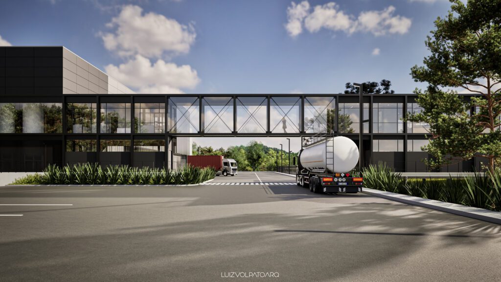 Um edifício industrial moderno, com uma passarela de vidro, conecta duas estruturas sobre uma rua. Um caminhão-tanque branco e um caminhão vermelho estão próximos à faixa de pedestres. Plantas e árvores de folhagem exuberante margeiam a área. Acima, o céu azul com nuvens esparsas. - Luiz Volpato Arquitetura